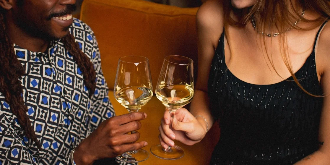 Couple cheering with wine glasses at Alpino - Date Night Dinners