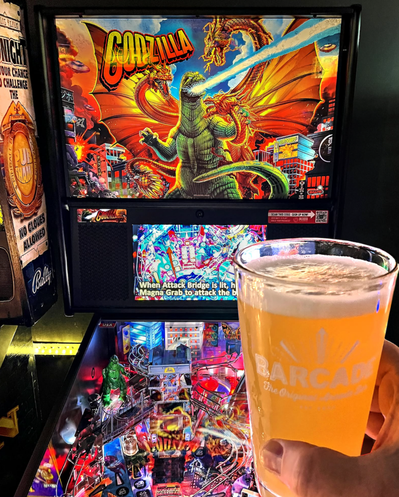 Godzilla pinball machine and glass of beer from Barcade