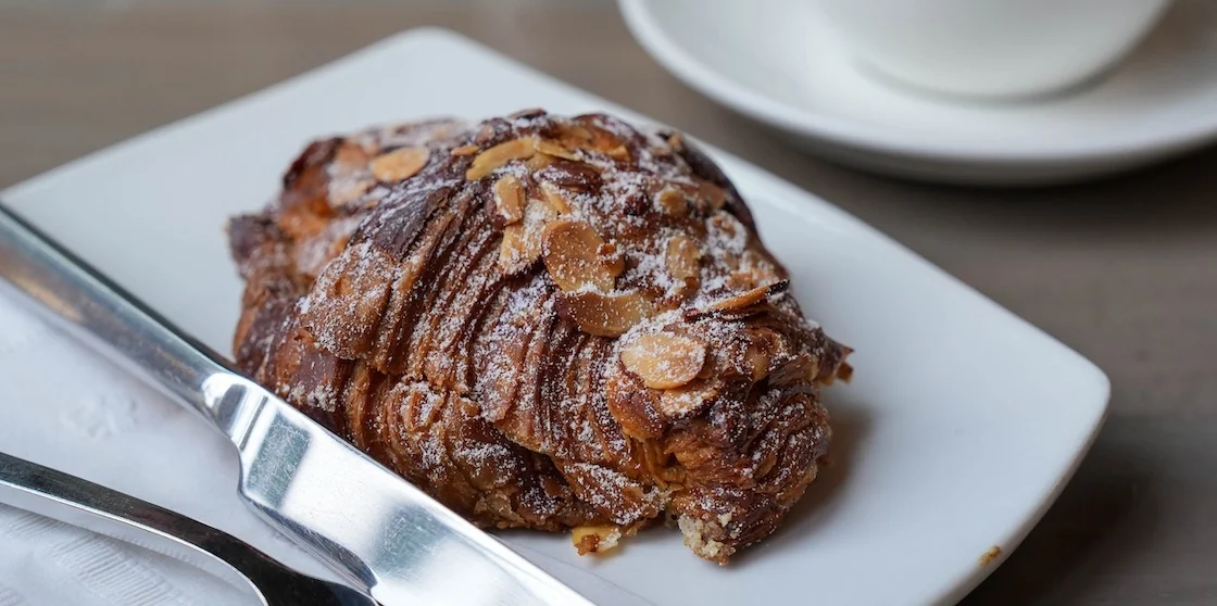 almond croissant with cutlery from Cannelle by Matt Knio photographed by Cat Sareini