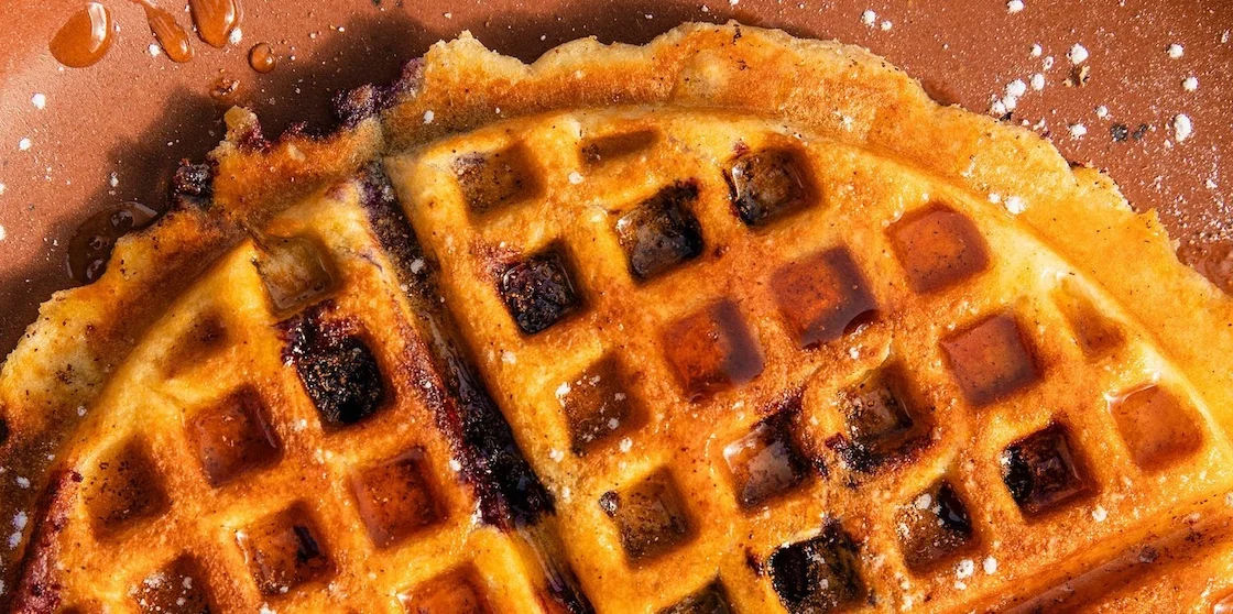 folk waffles with powdered sugar and syrup