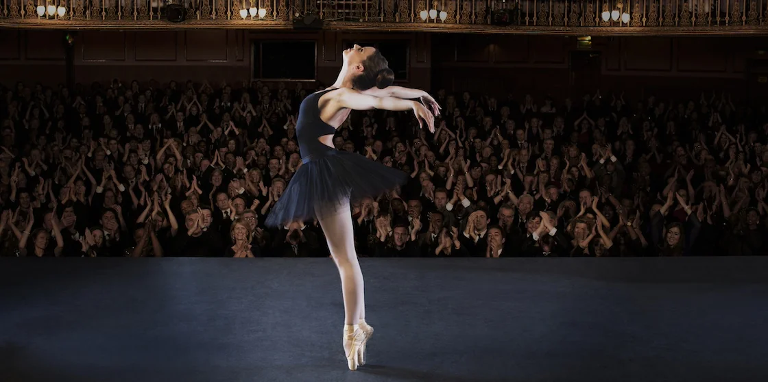 Ballerina performing on stage in front of a crowd - holiday musicals