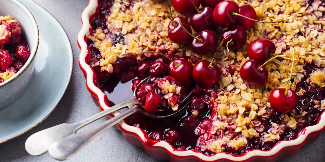 red berry and cherries crumble in baking dish.