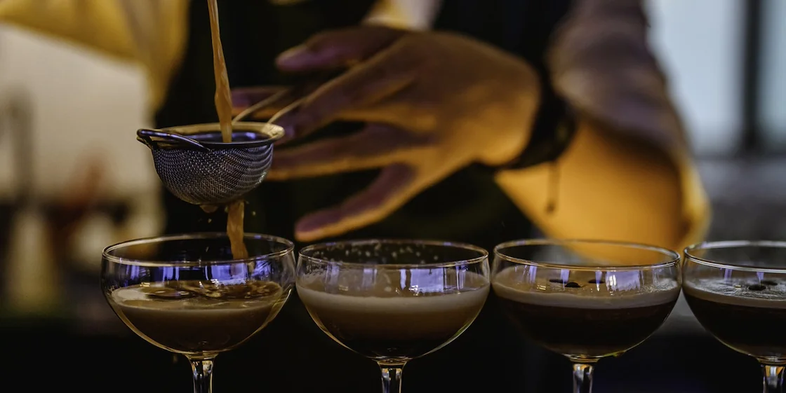 Bartender making cocktails at a bar - late night drinks