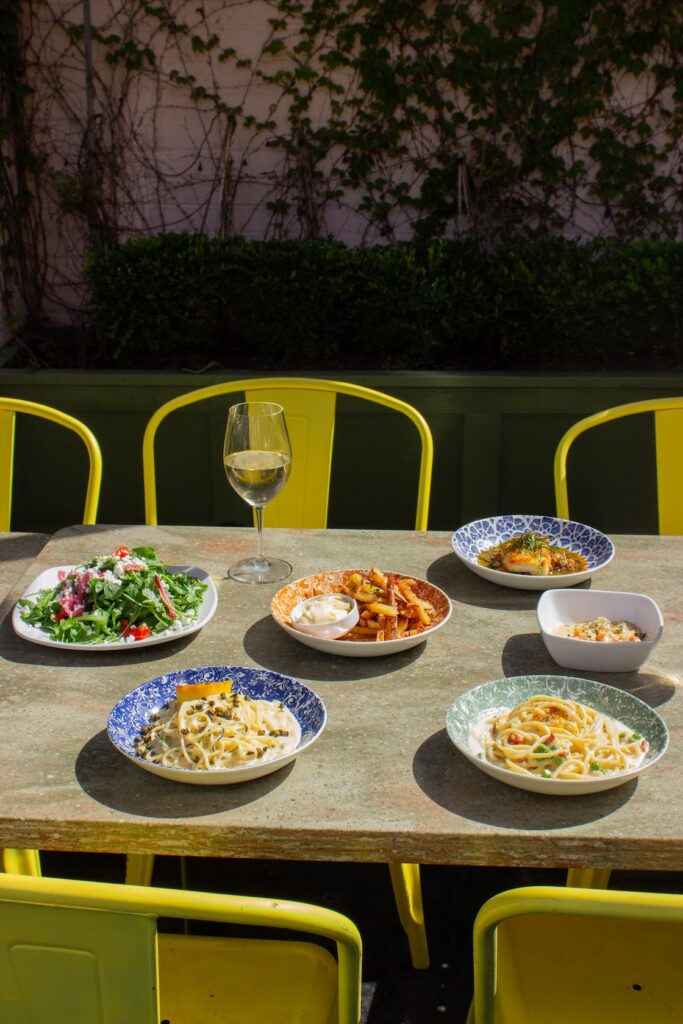 Variety of pasta dishes, salads, and more on Bella Limone's outdoor patio dining space