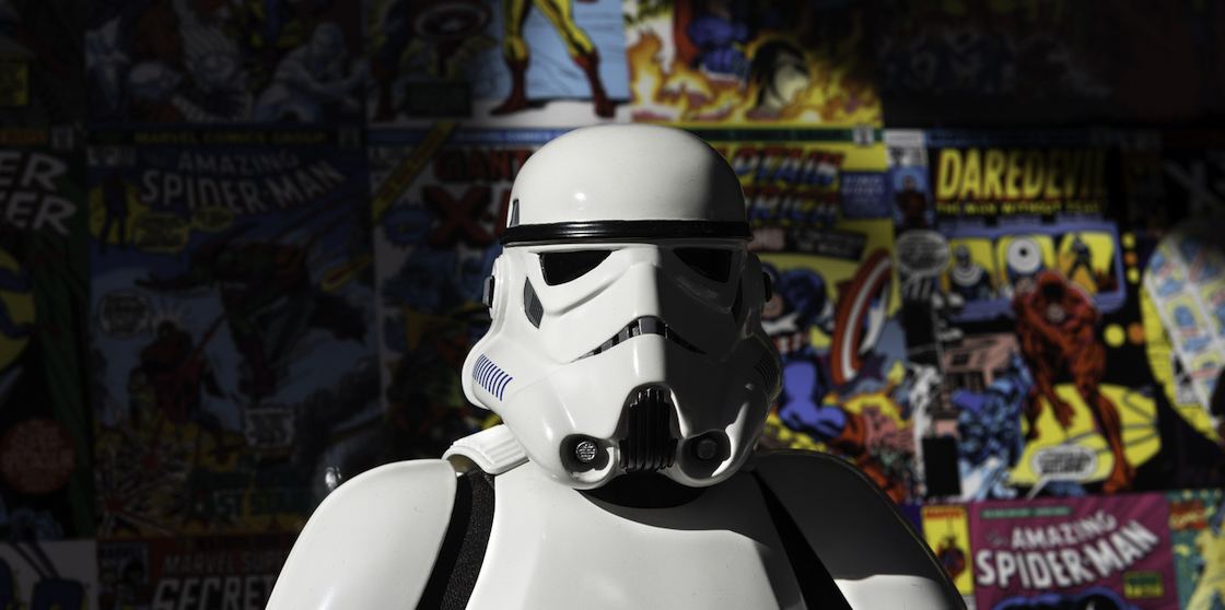 Star wars stormtrooper in front of comics representing comic con