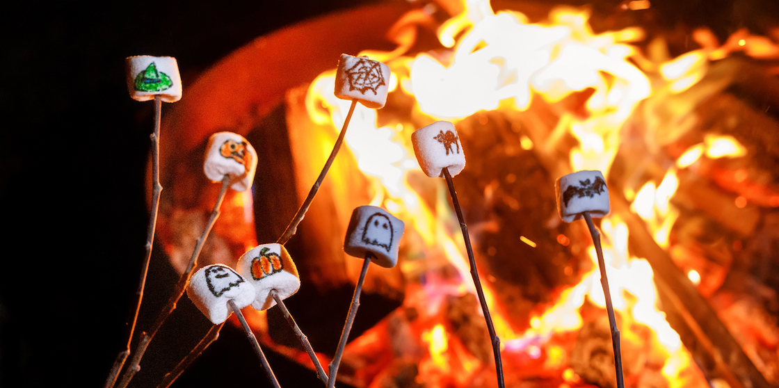 halloween themed marshmallows roasted over a fire. halloween activities of making smores