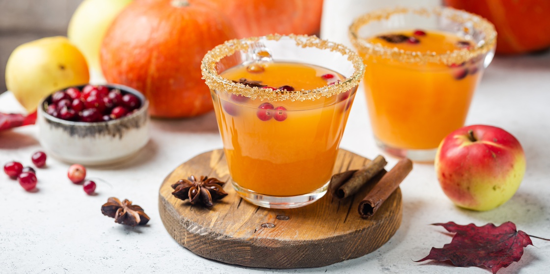 Spicy hot pumpkin punch or sangria in a glass with apple, cinnamon, anise. Halloween and Thanksgiving. Traditional autumn, winter drinks and cocktails - fall cocktails