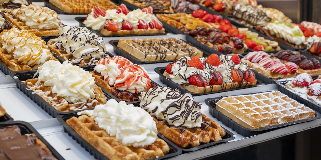 national food waffles in Belgium on the square in pastry shops with chocolate cream and berries