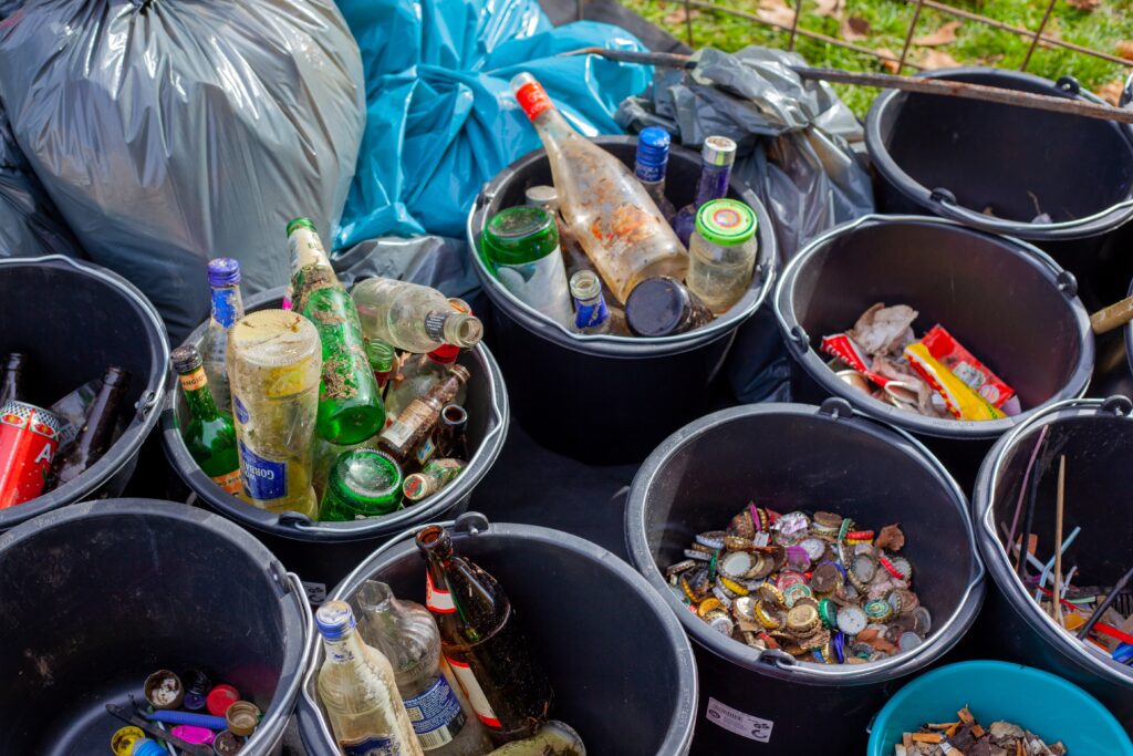 Trash, glass bottles and other recyclables organized into bins
