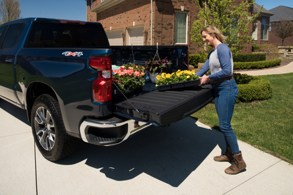 woman loads flowers into the Chevy SIlverado