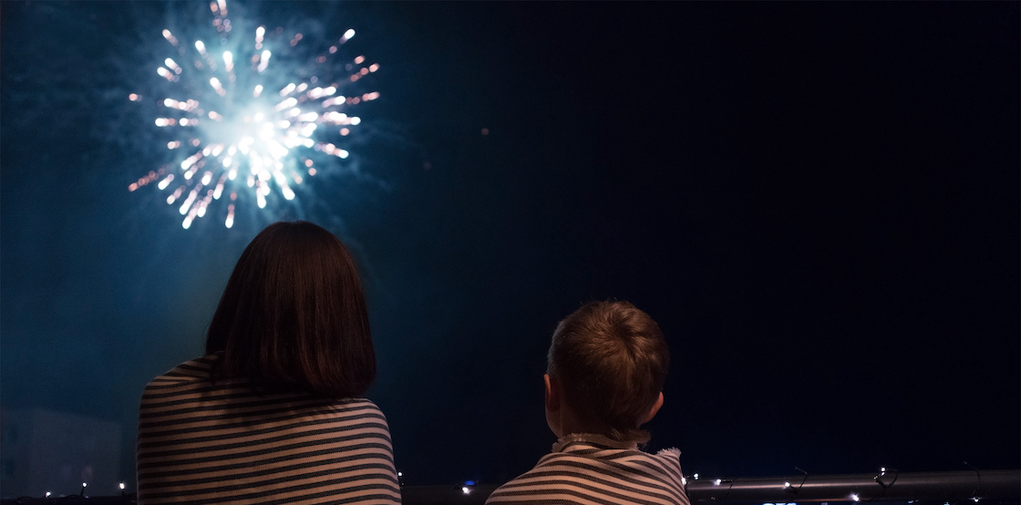 Mother and son watch fireworks display