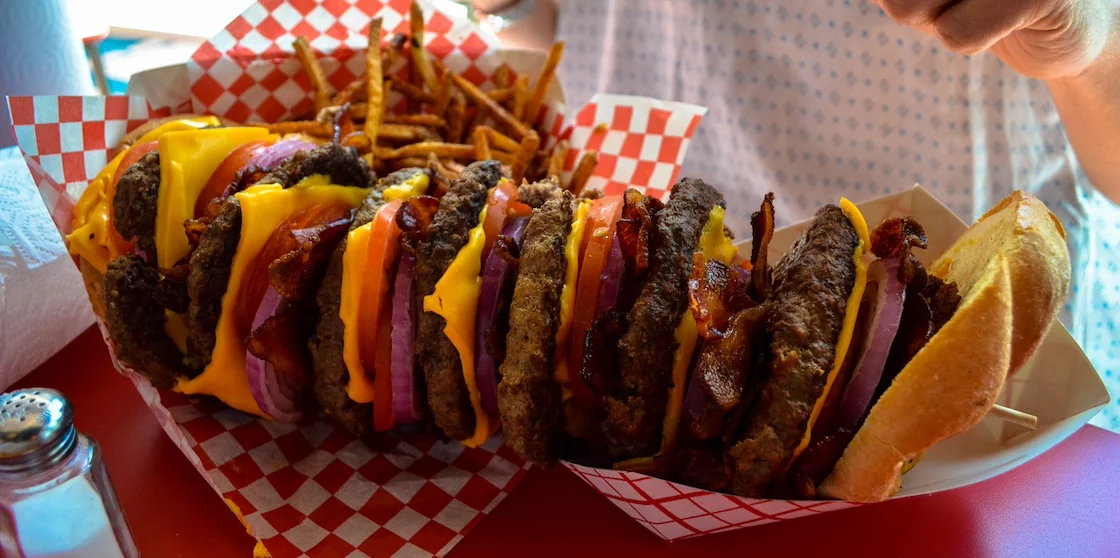 giant Burger and fries challenge about to get eaten