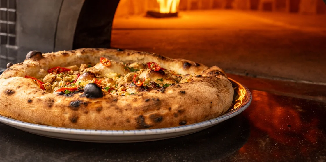 Neapolitan pizza emerges from a blazing wood-fired restaurant oven - Downriver Dining