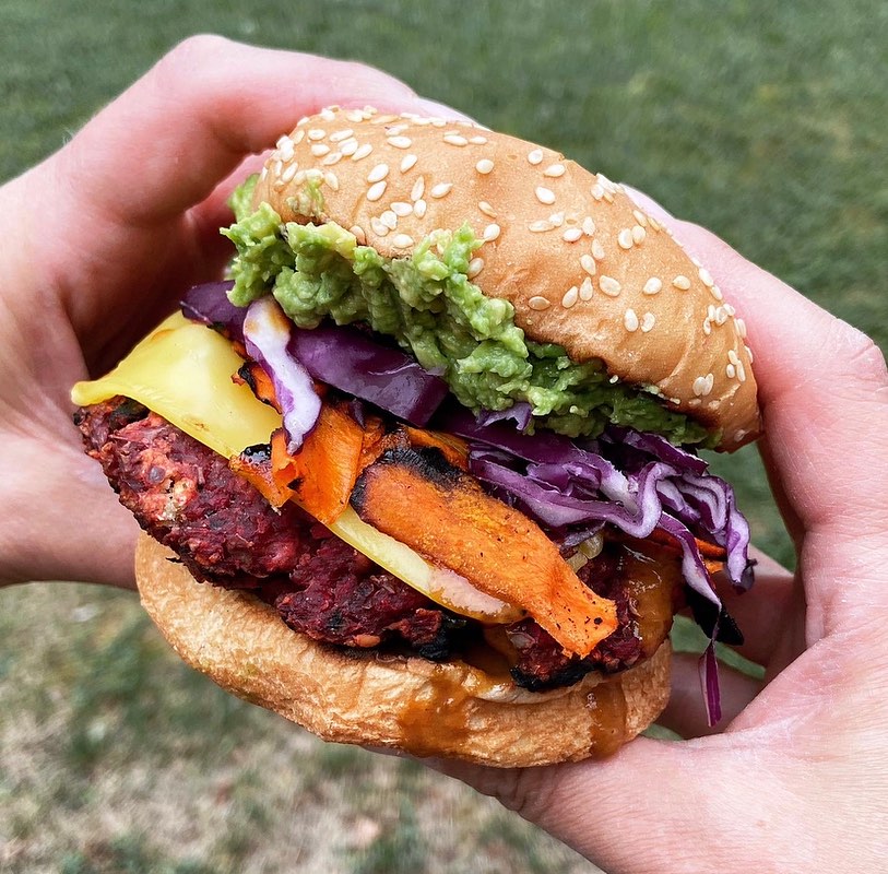 burger from spacecat v-stro with sweet potato, guacamole, cabbage, and more