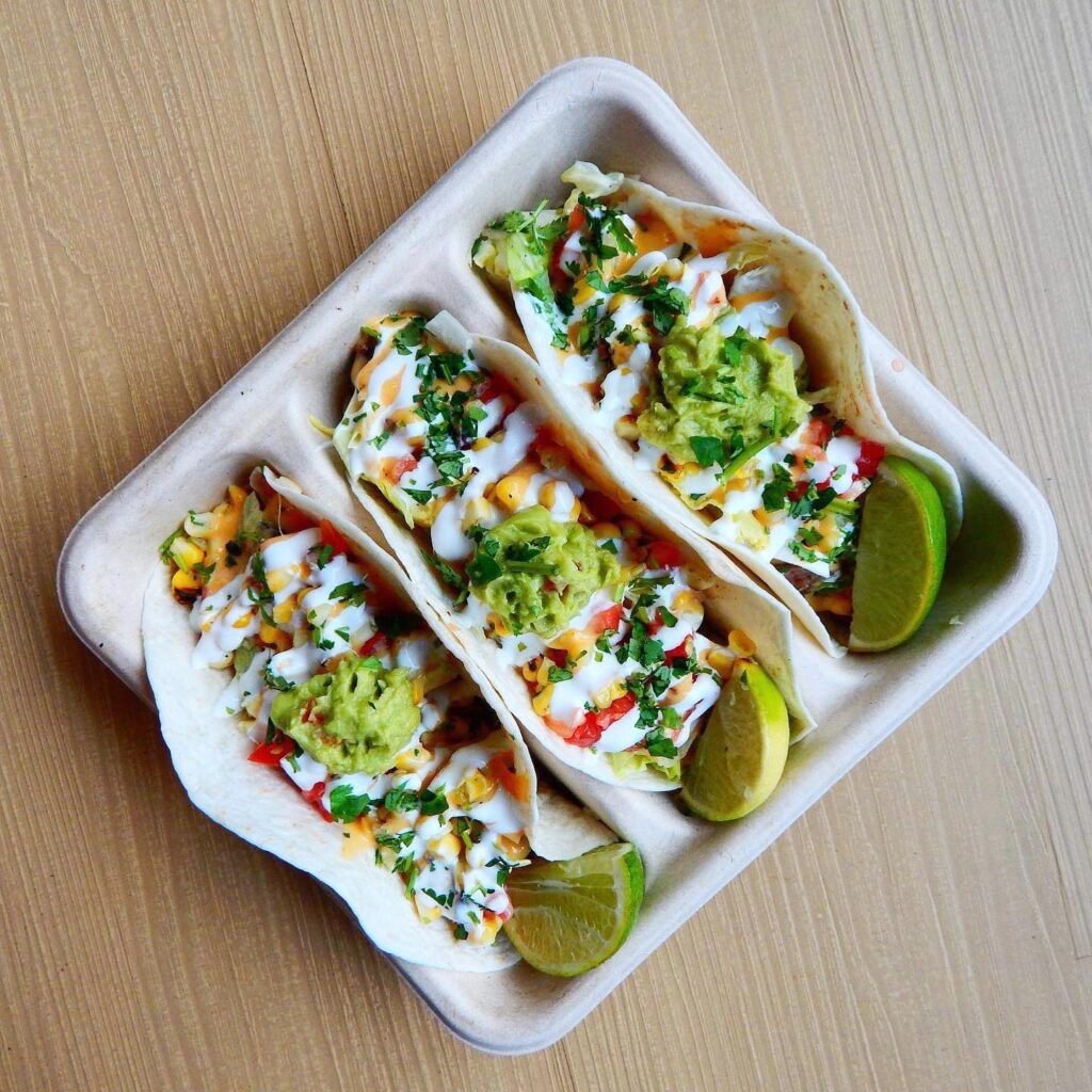 three tacos in a tray from UWM District market