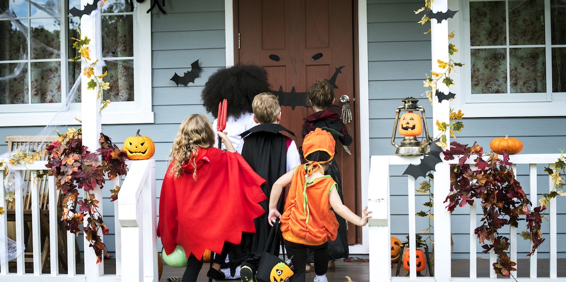 kids walking up a porch while trick or treating