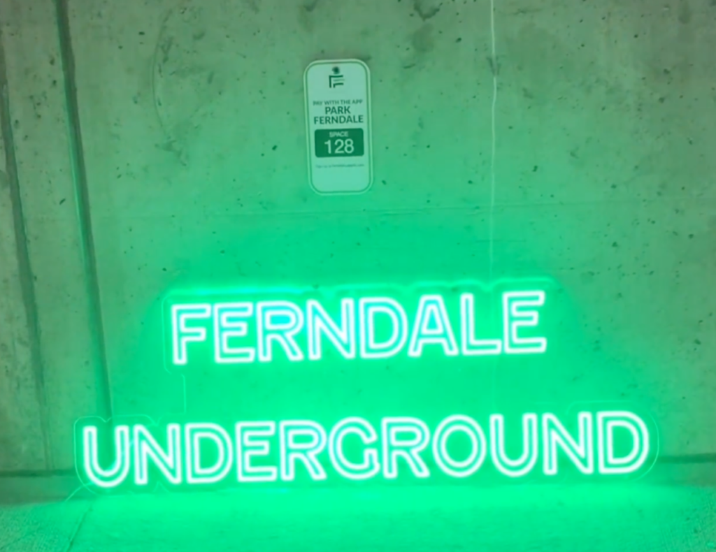 ferndale underground market neon green sign in parking garage november event - holiday market
