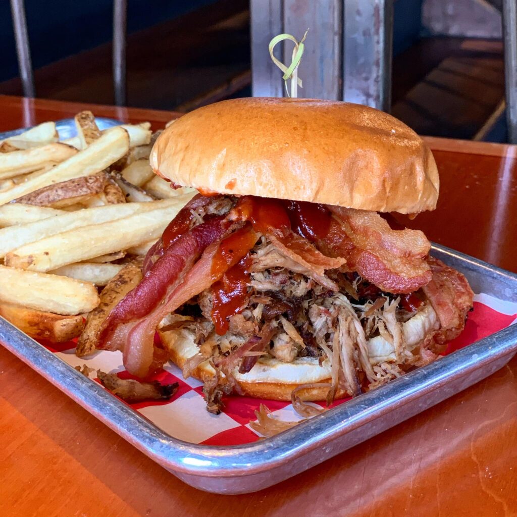 pulled pork sandwich with bacon and fries from hockeytown cafe
