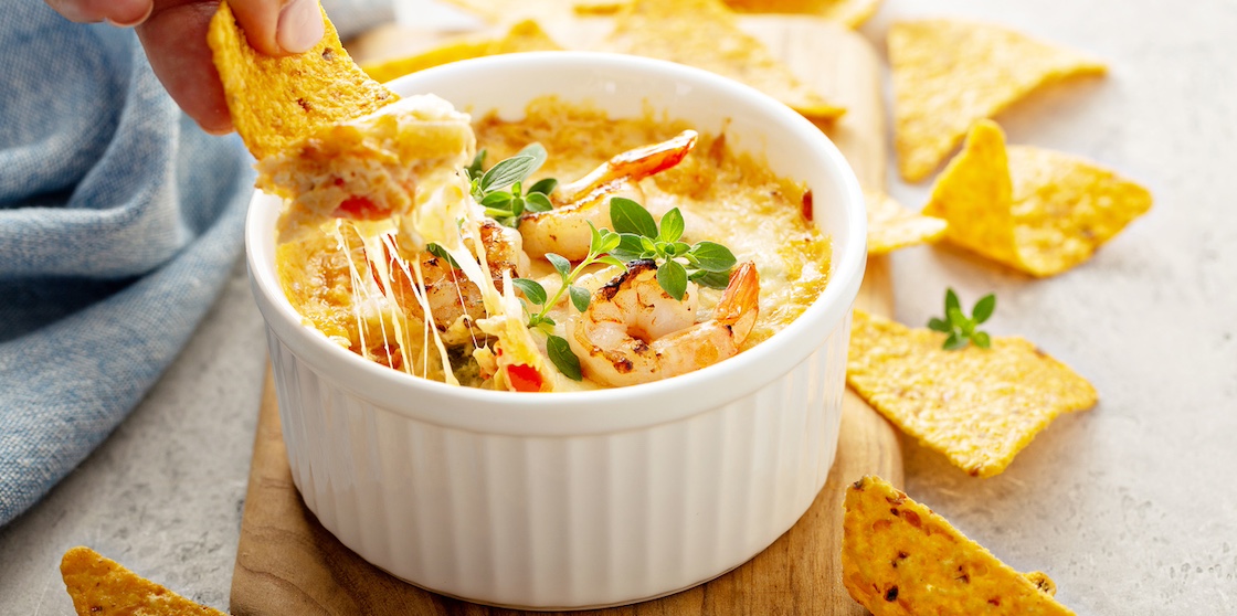 Spicy seafood dip in a ramekin with corn chips - dips