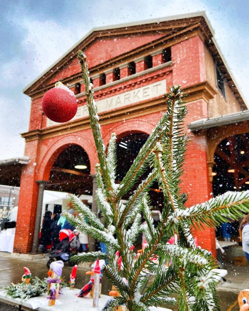 eastern market shed with snowy christmas tree with one red bulb - holiday events markets