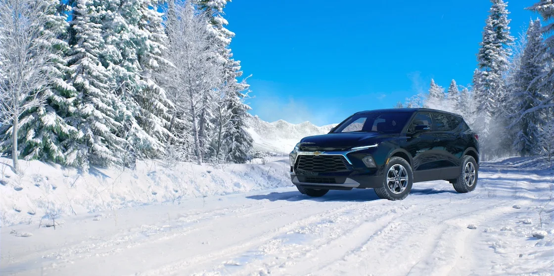 black 2024 chevy blazer in snow with trees