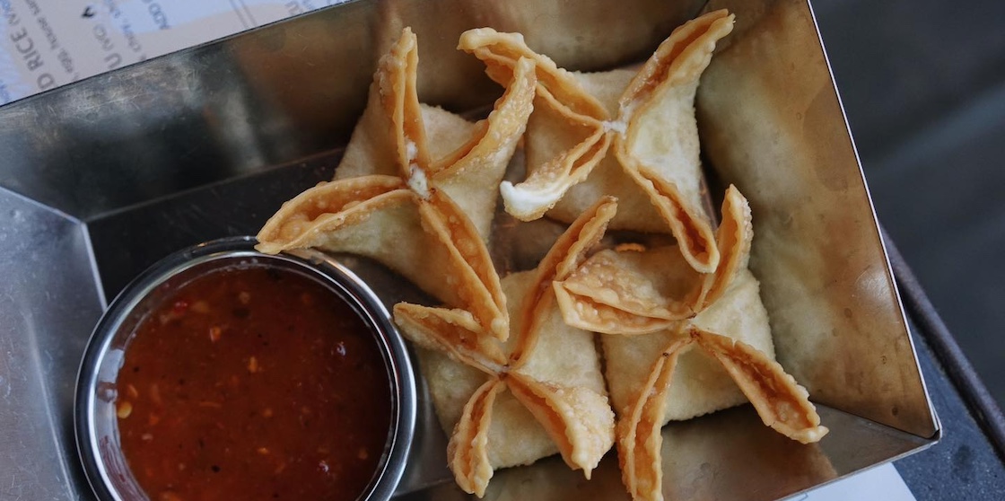 wontons and sauce in a tray