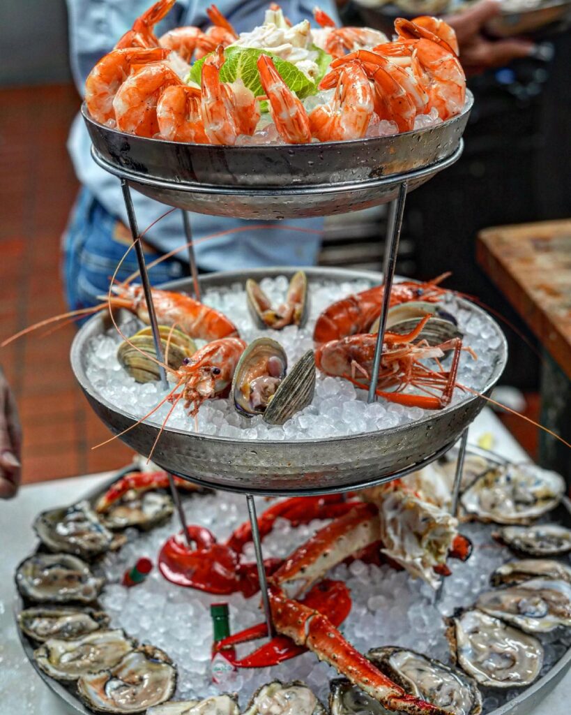 three tiered seafood tower from tom's oyster bar with oysters, crab, and shrimp