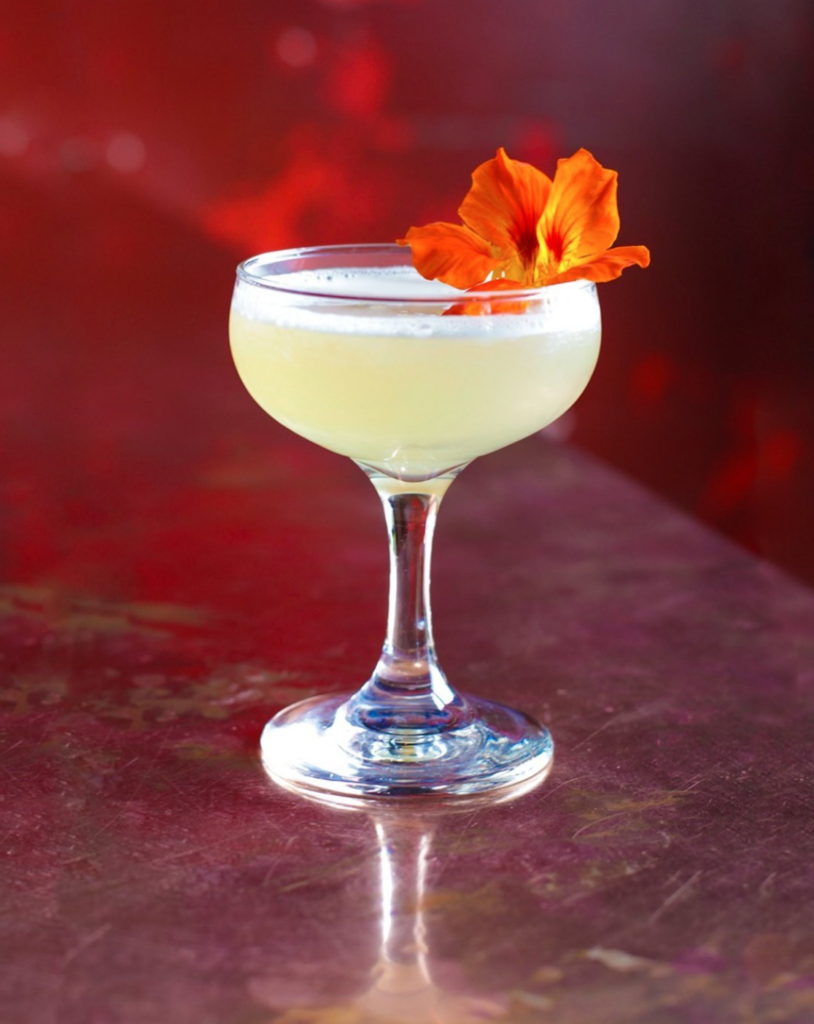 cocktail with an orange flower from valentine distilling