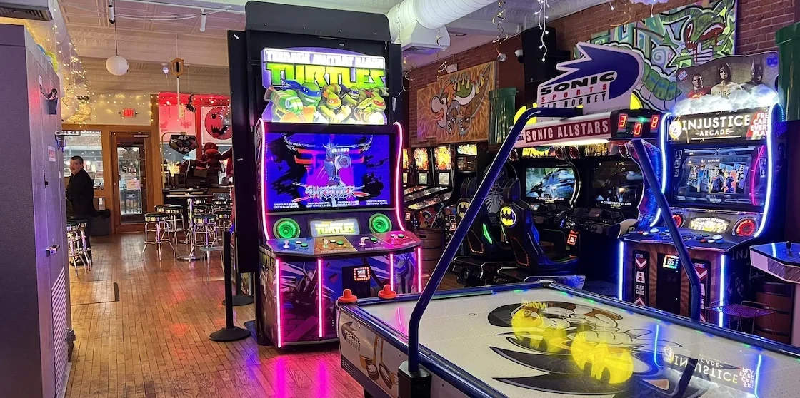 1up arcade bar with games, air hockey table, and more