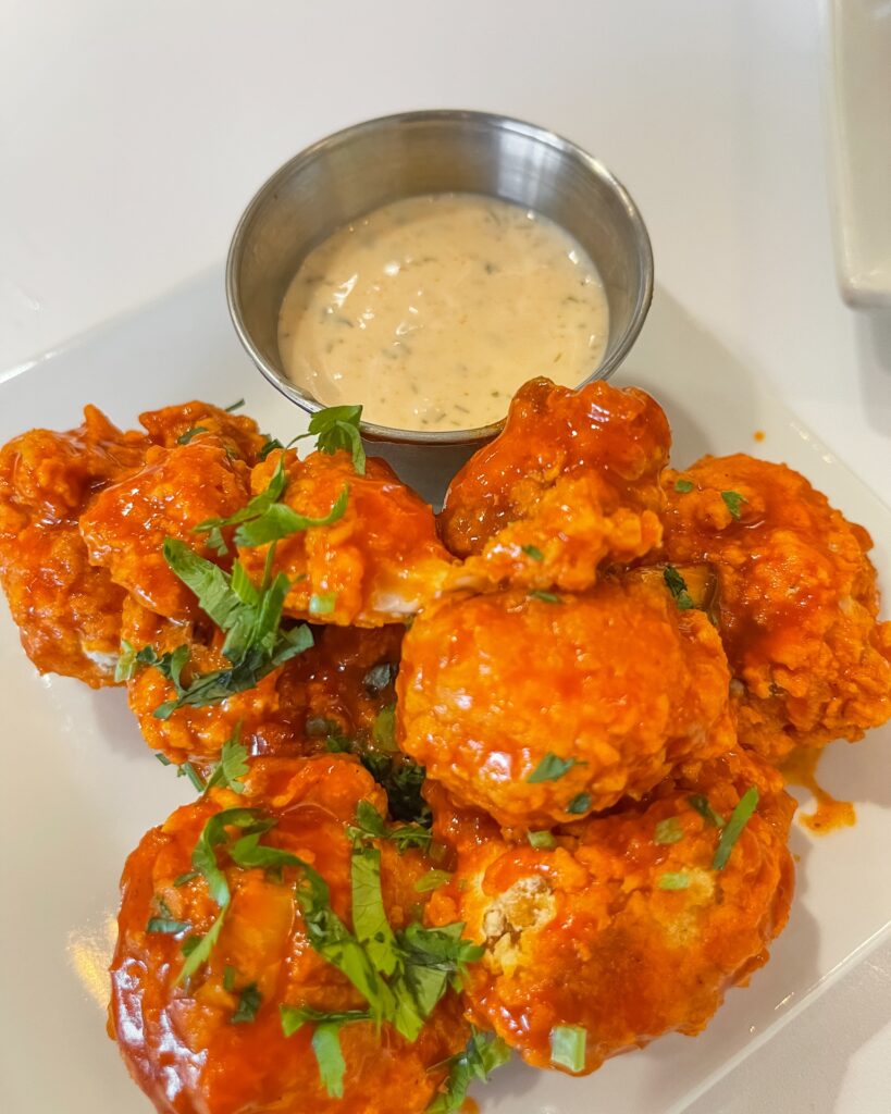 plate of buffalo cauliflower wings with a side of ranch from the kitchen by cooking with que