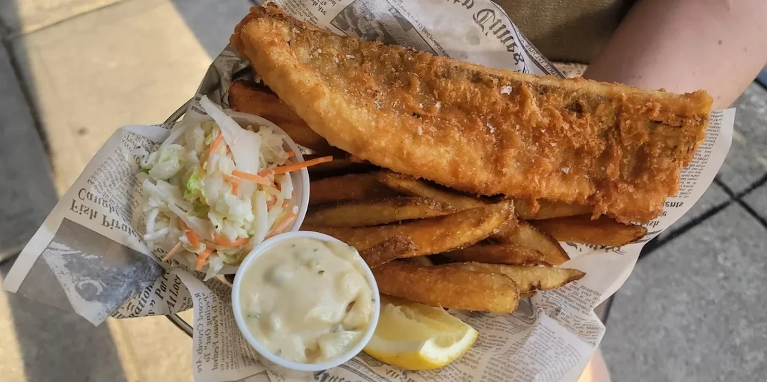 common pub fish and chips tray with lemon and coleslaw