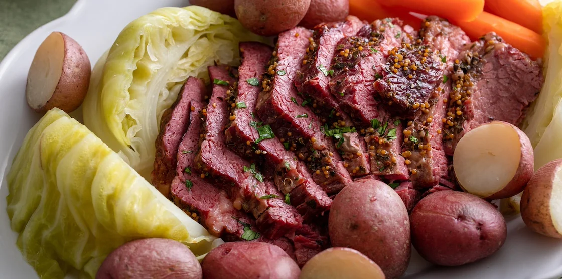 Corned beef sliced served with cabbage, potatoes and carrot, traditional Irish recipe for Saint Patricks day