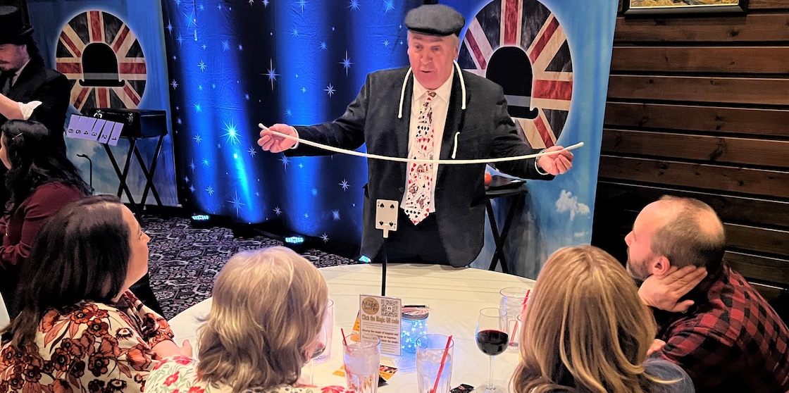 magic soiree performer at a guest's table