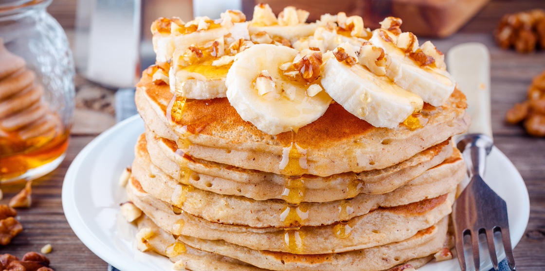 Breakfast oatmeal pancakes with banana, walnuts and honey