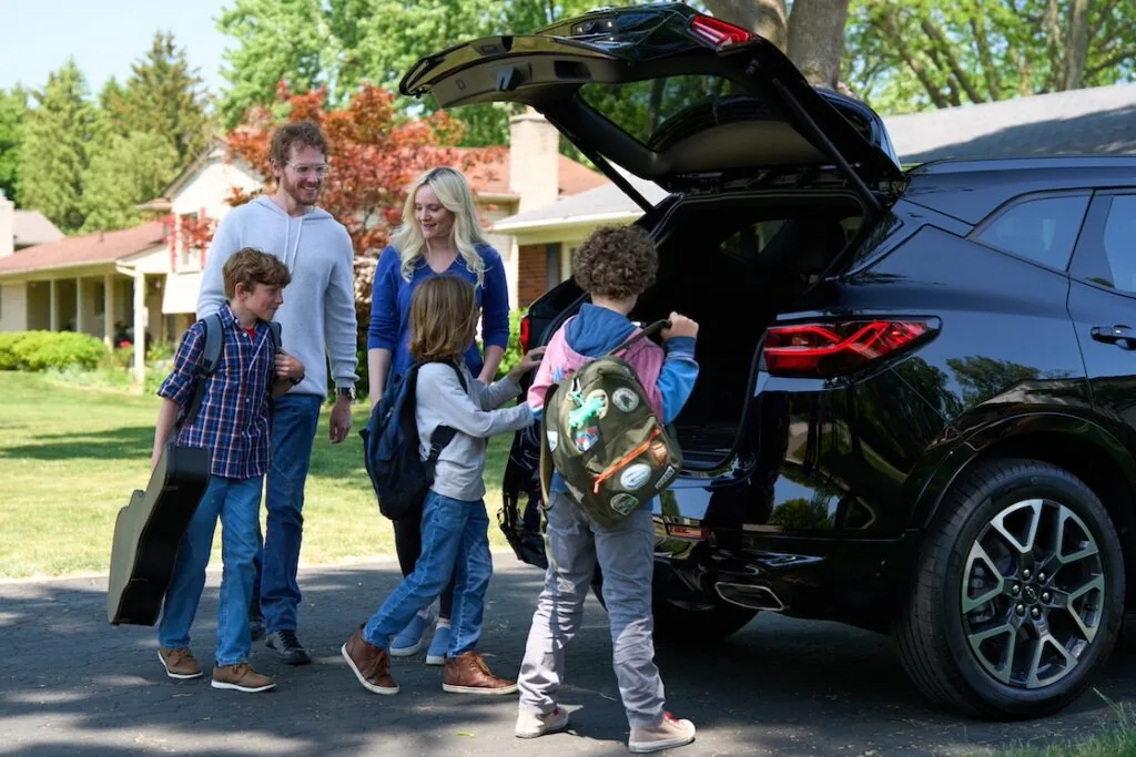 family loading items into the cargo space of the blazer.