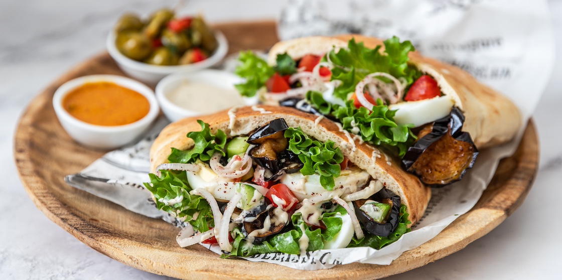 Sabich sandwich - pita stuffed with fried eggplant and hard boiled eggs and salad