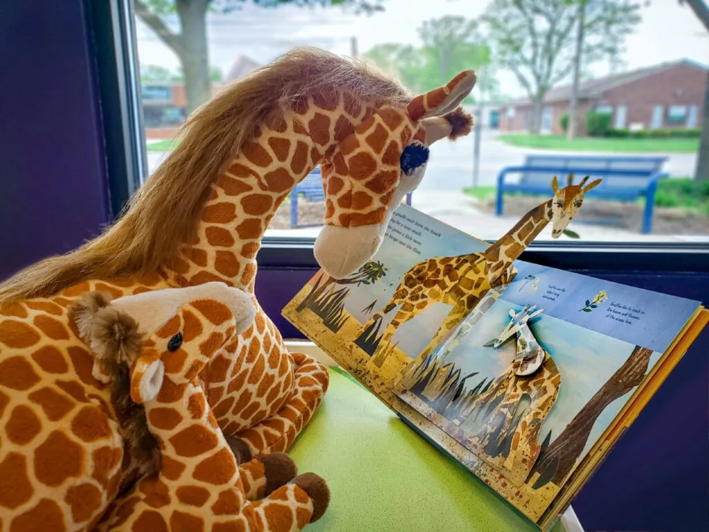 plush giraffes reading at whistle stop hobby & toy - toy stores