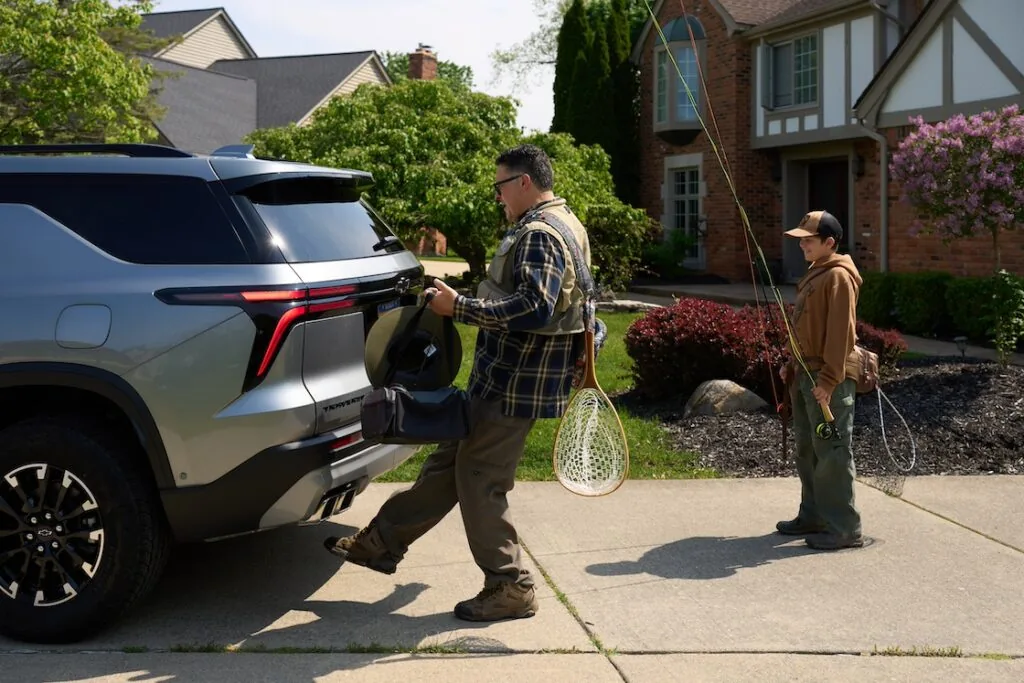 father and son approaching the rear of an all-new traverse with fishing gear