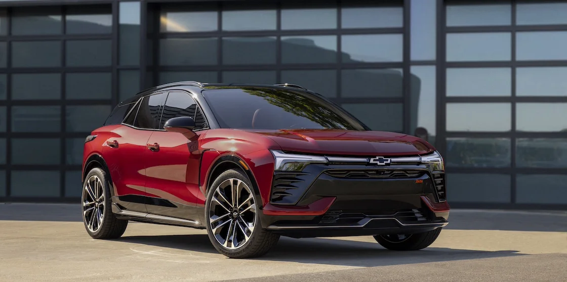 red chevy blazer ev in front of glass doors