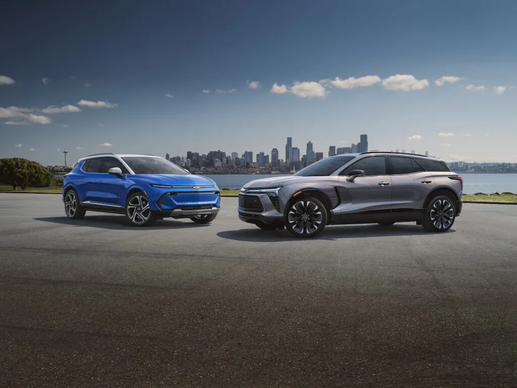 blazer ev and equinox ev set in front of the detroit skyline