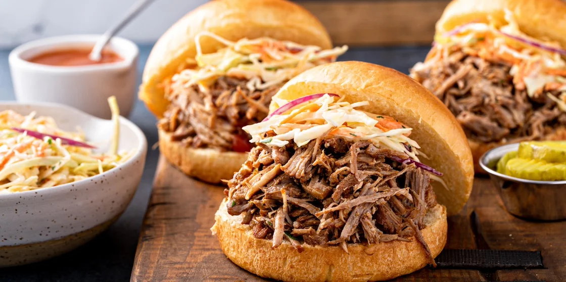 Pulled pork sandwiches with coleslaw and bbq sauce on brioche buns