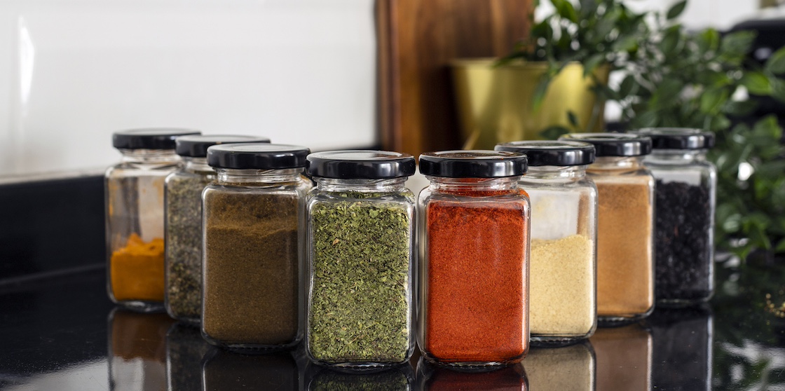 Various dried spices in glass jars