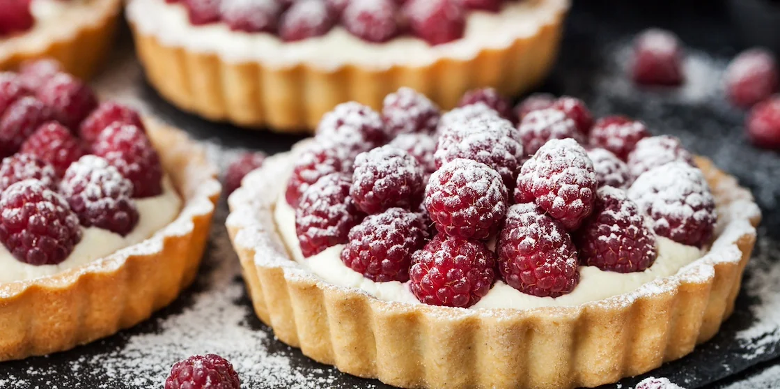 Delicious raspberry mini tarts (tartlets) with whipped cream desserts