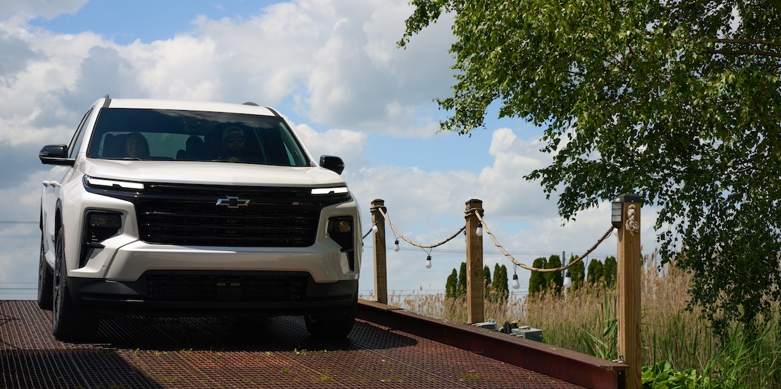 white traverse with family crossing a ferry bridge