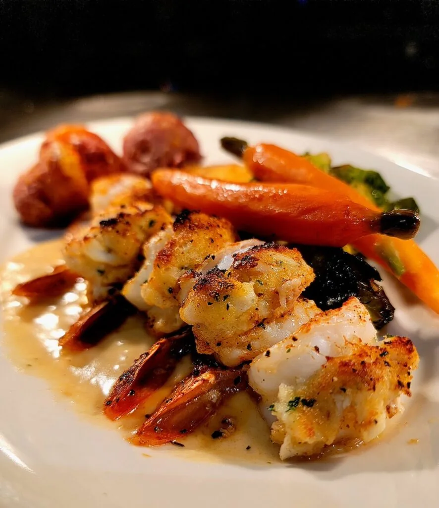 crab stuffed shrimp with potatoes and roasted vegetables