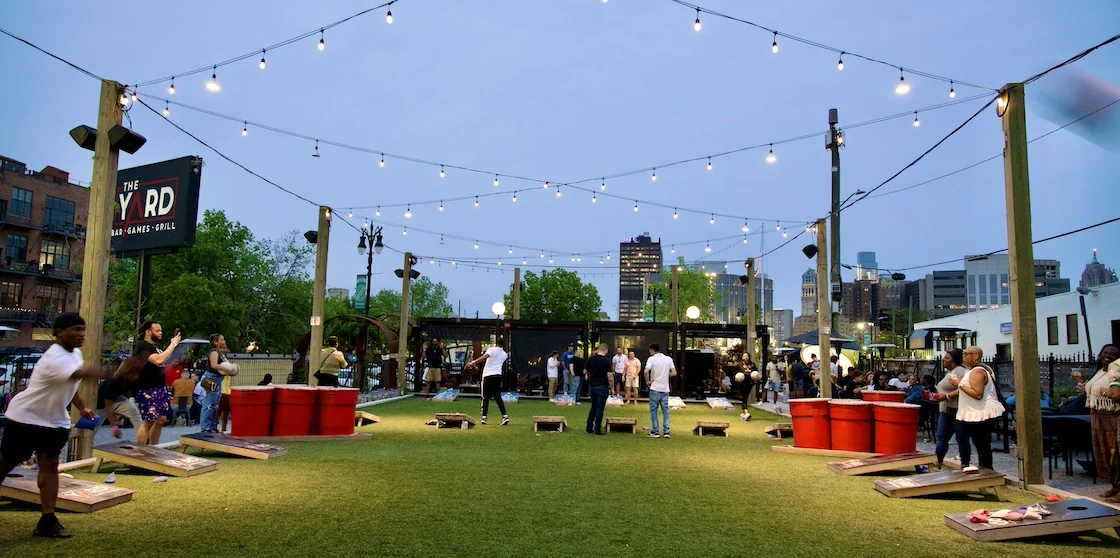 The Yard outdoor game space with corn hole and pong