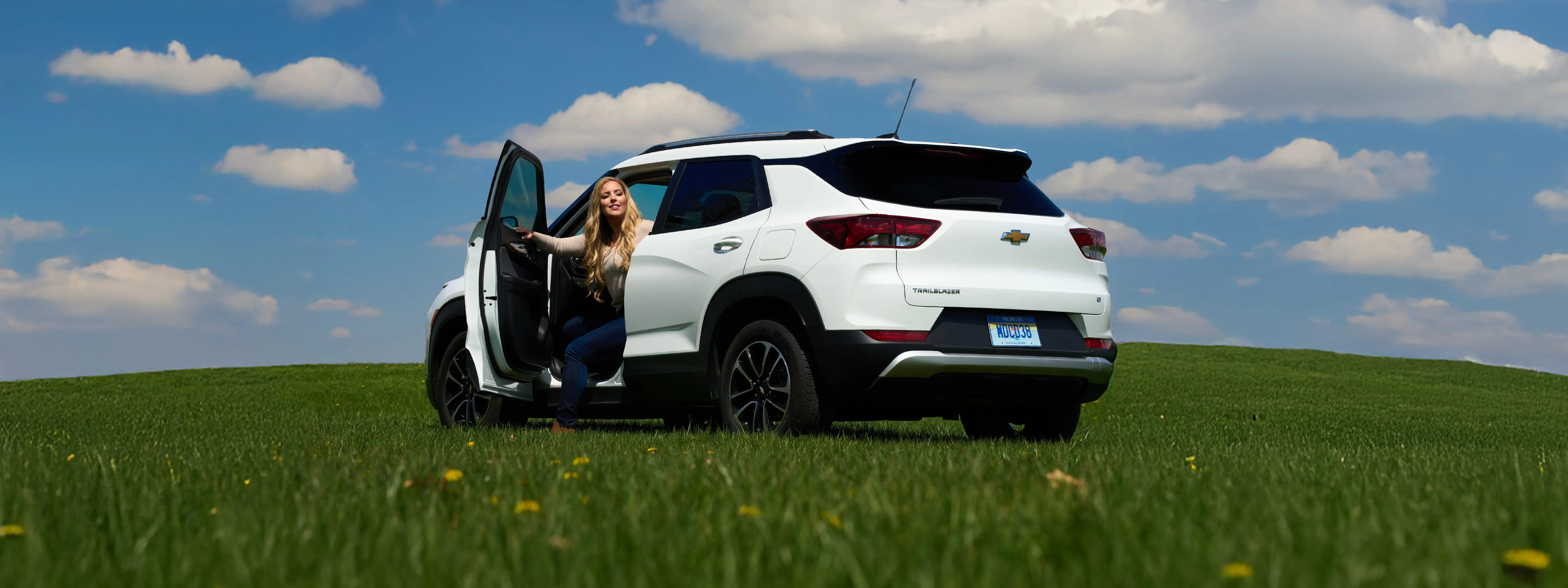 Shannon exiting a white Trailblazer