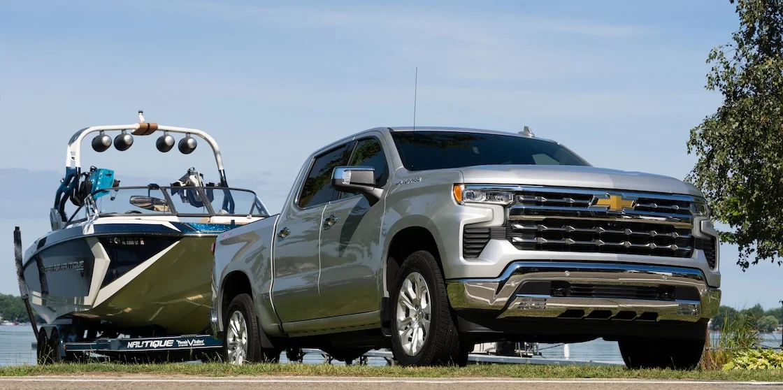 Silver Chevy Silverado towing a boat