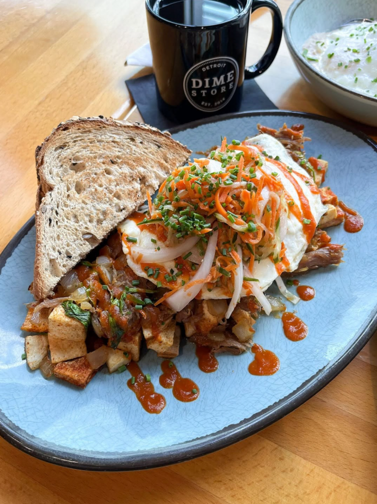 Dime Store savory housemade hash with toast, a fried egg, and a cup of coffee