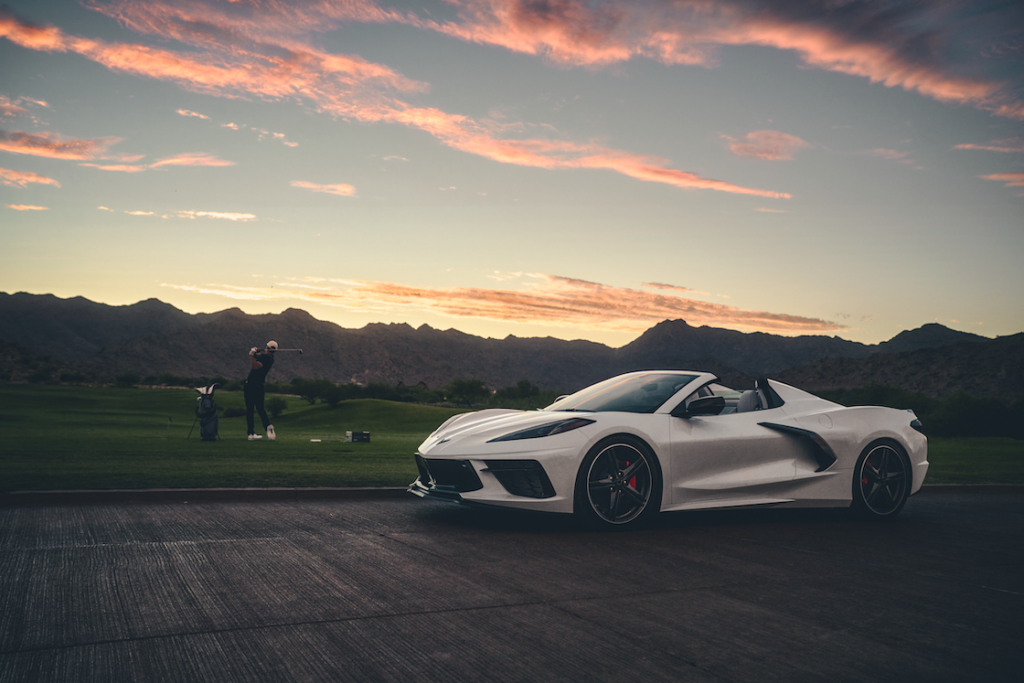 White Corvette Stingray Convertible during a sunset golf session